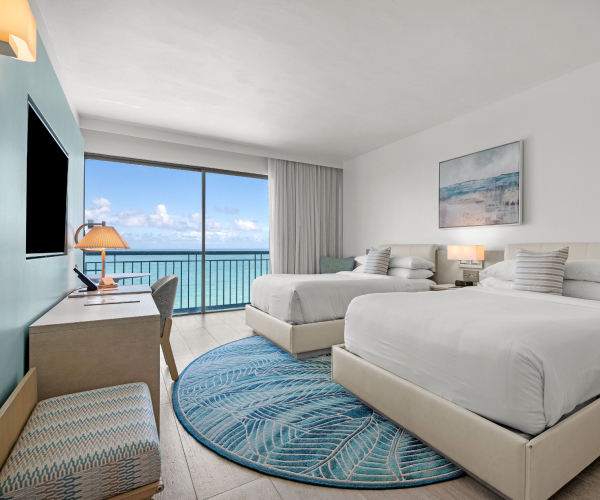 La Concha Resort Ocean Tower Guest room with two queen beds, a balcony, and an ocean view