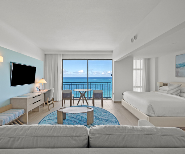 La Concha Resort Ocean Tower junior suite with a king bed and a cozy couch with ocean view
