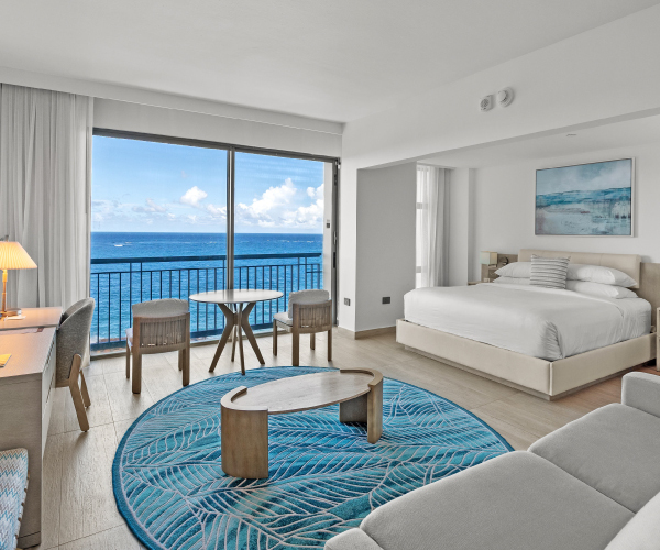 La Concha Resort Ocean Tower junior suite with a king bed and a cozy couch with ocean view