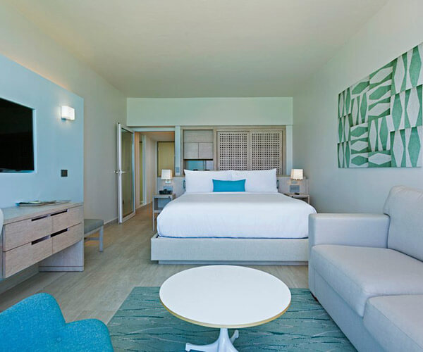 Guest room with a king bed and a small seating area