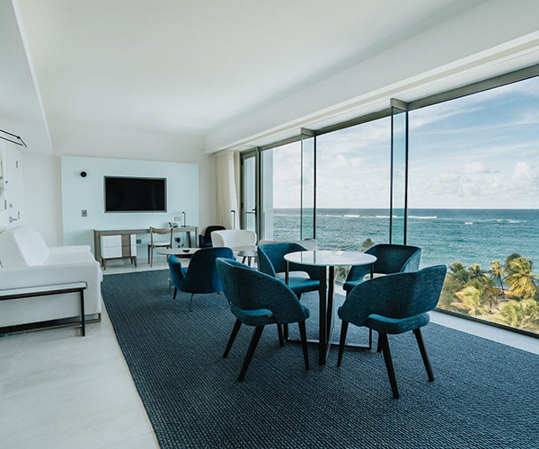 Living room area with table and couch with ocean views