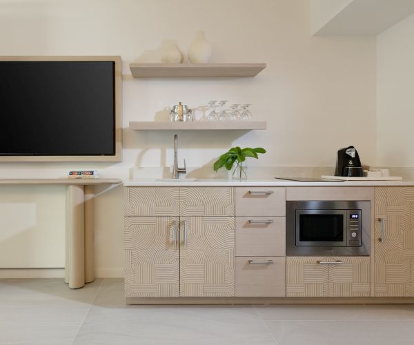 Kitchenette with a microwave, wet bar, and an assortment of coffee