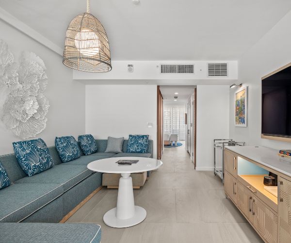 Living area with blue couches and TV
