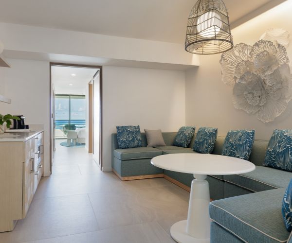 Living room with blue couches and kitchenette