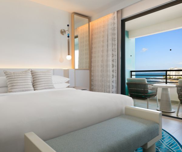 Bedroom with a partial ocean view
