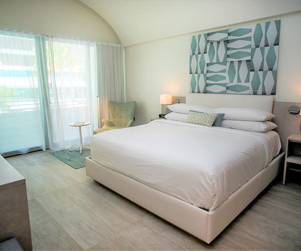 Guest room with sheer curtains and a view of the resort