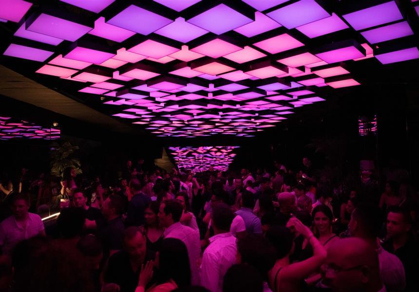 A nightclub with pink and purple lights