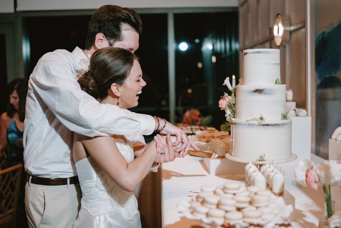 The bride and groom cutting cake