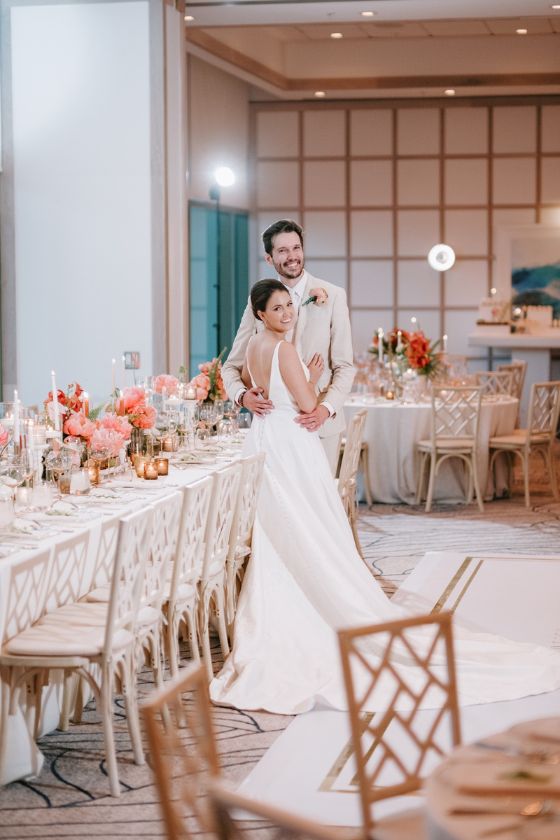 The bride and groom posing at ballroom