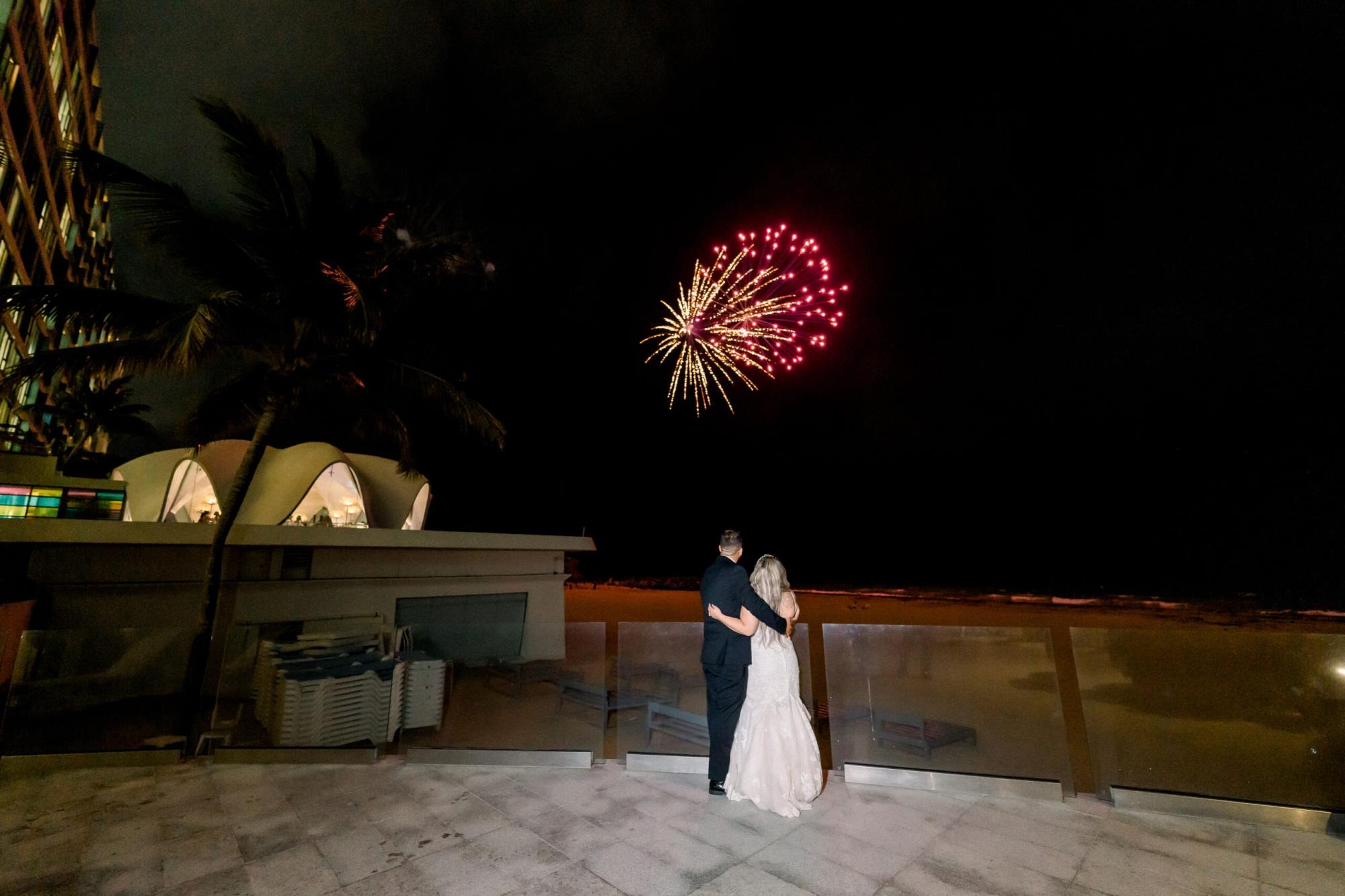 The bride and groom in front of fireworks