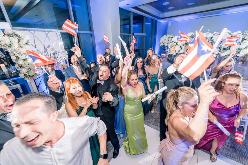 The bride and groom dancing with people