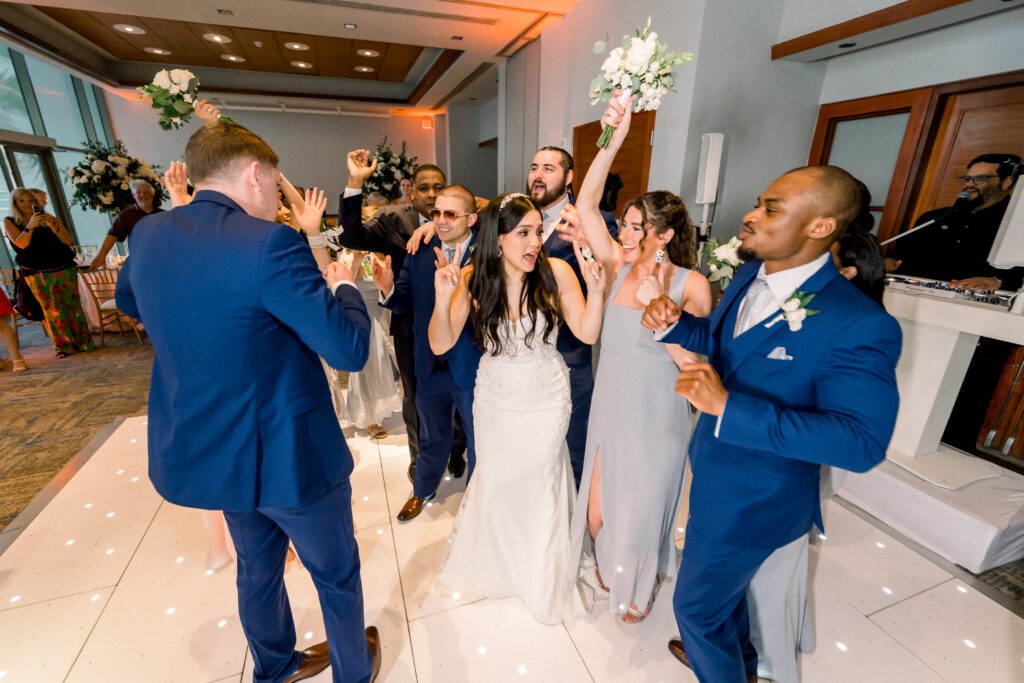 The bride and groom dancing with people