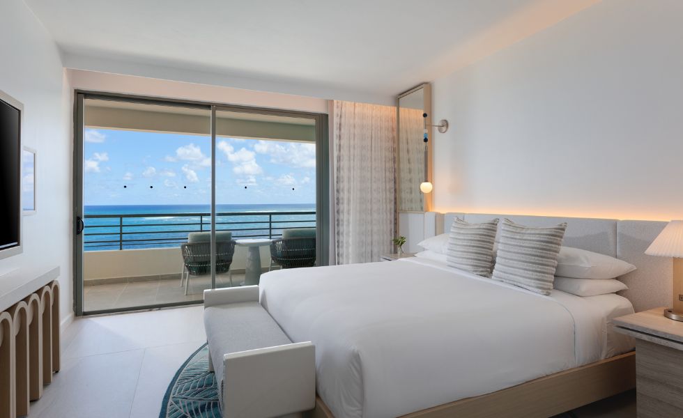 Bedroom with a king bed and a balcony
