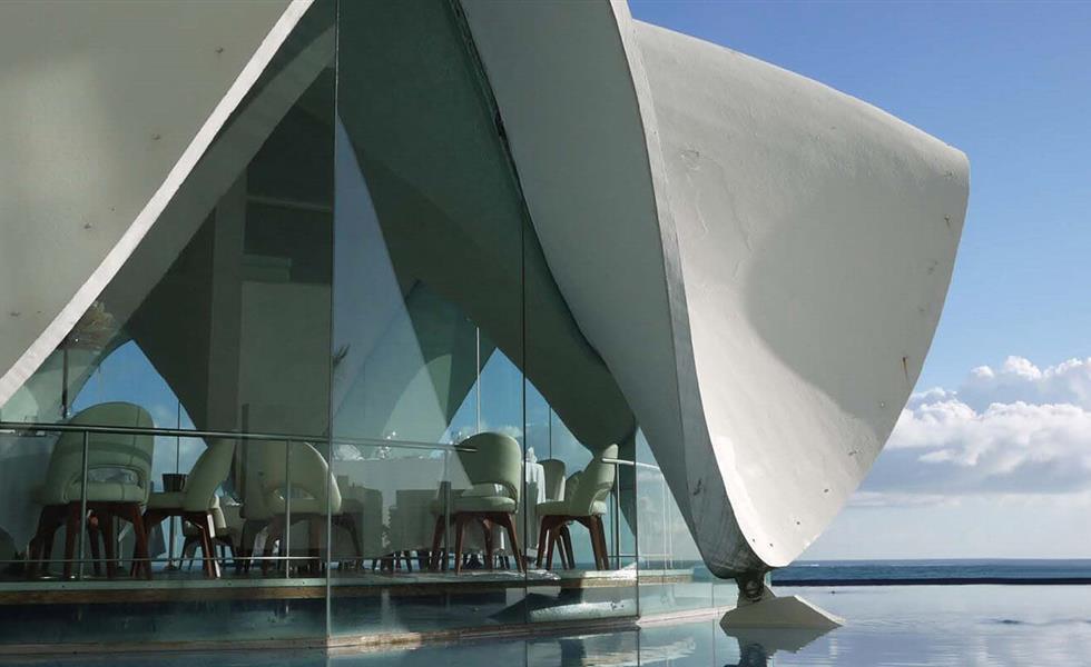 exterior of shell building near pool and beach