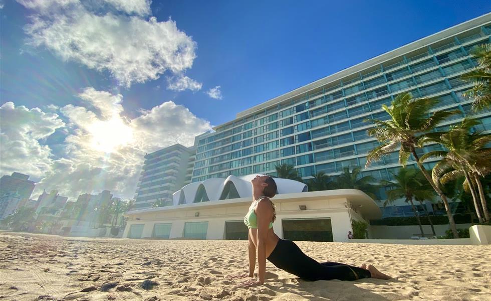 A woman stretching on a beach