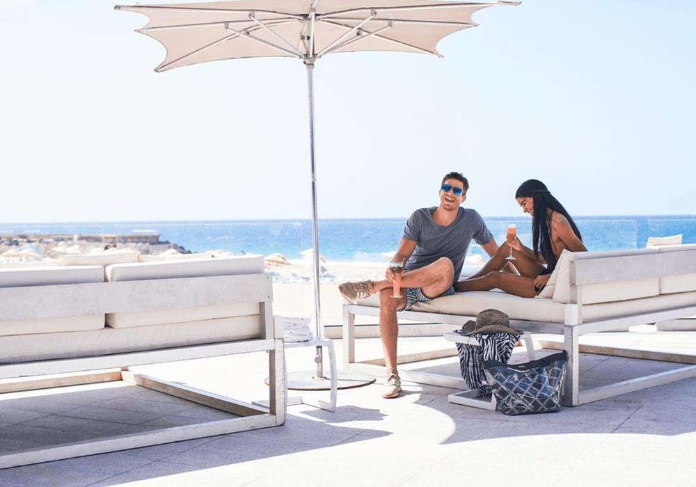 Two people talking and laughing by the beach