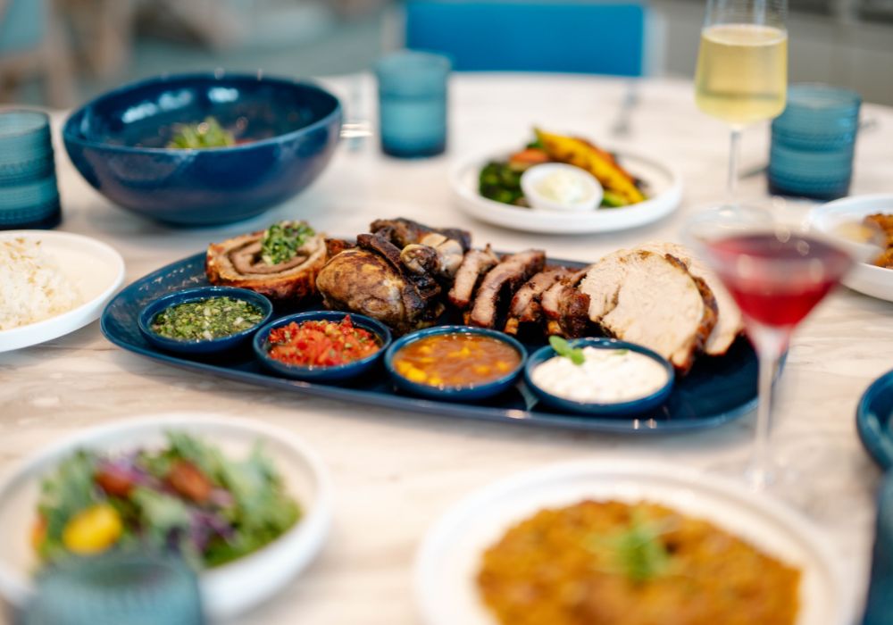 Rotisserie tray on table with more plates and glasses