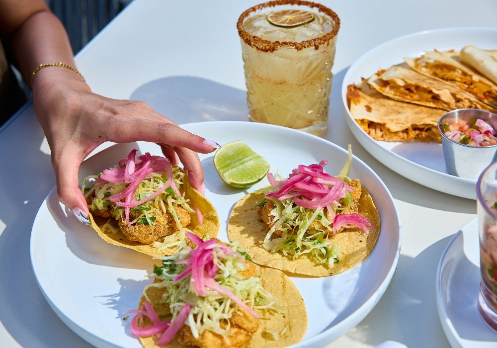 tacos and margarita on table at solera