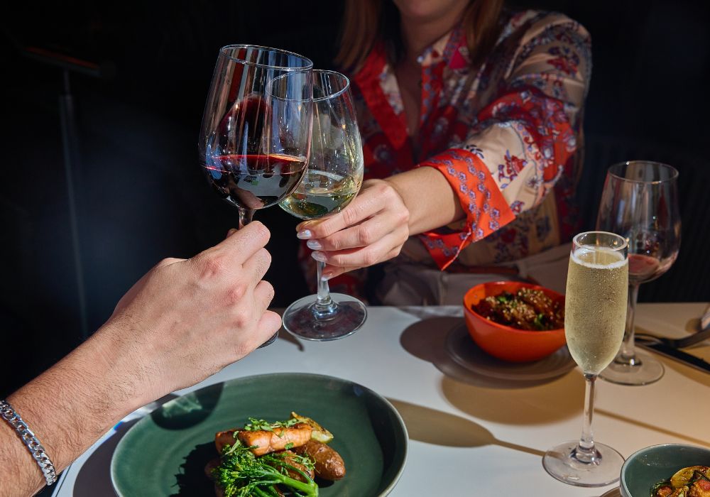 glasses clinking at solera dinner table
