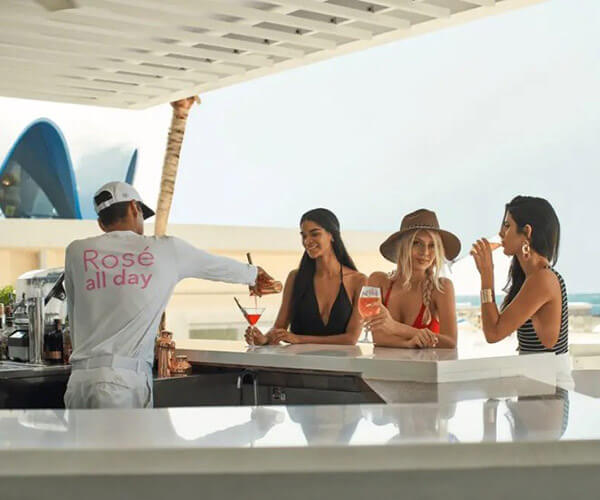 A group of women getting drinks and chatting at Marena Bar