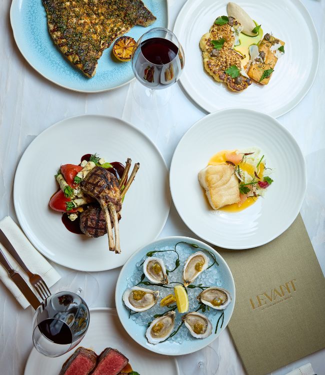 Plates of pasta, burrata, and a salad