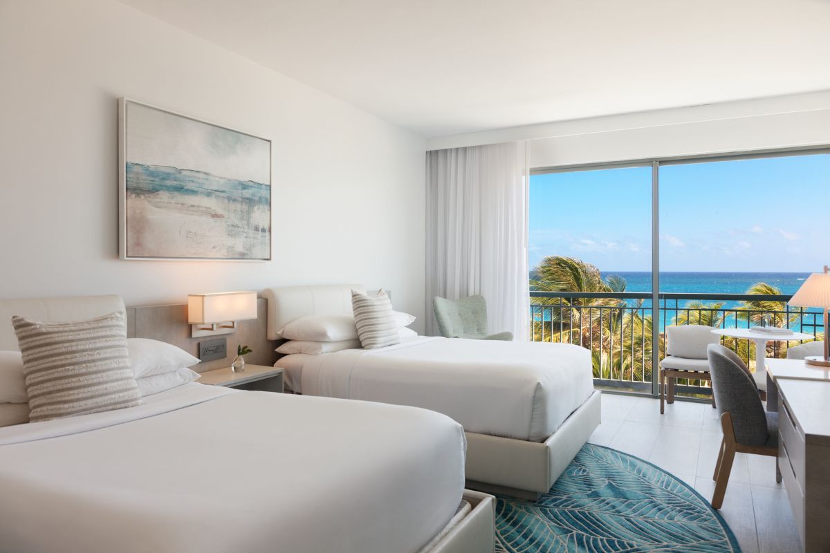 guest room with double beds and ocean view