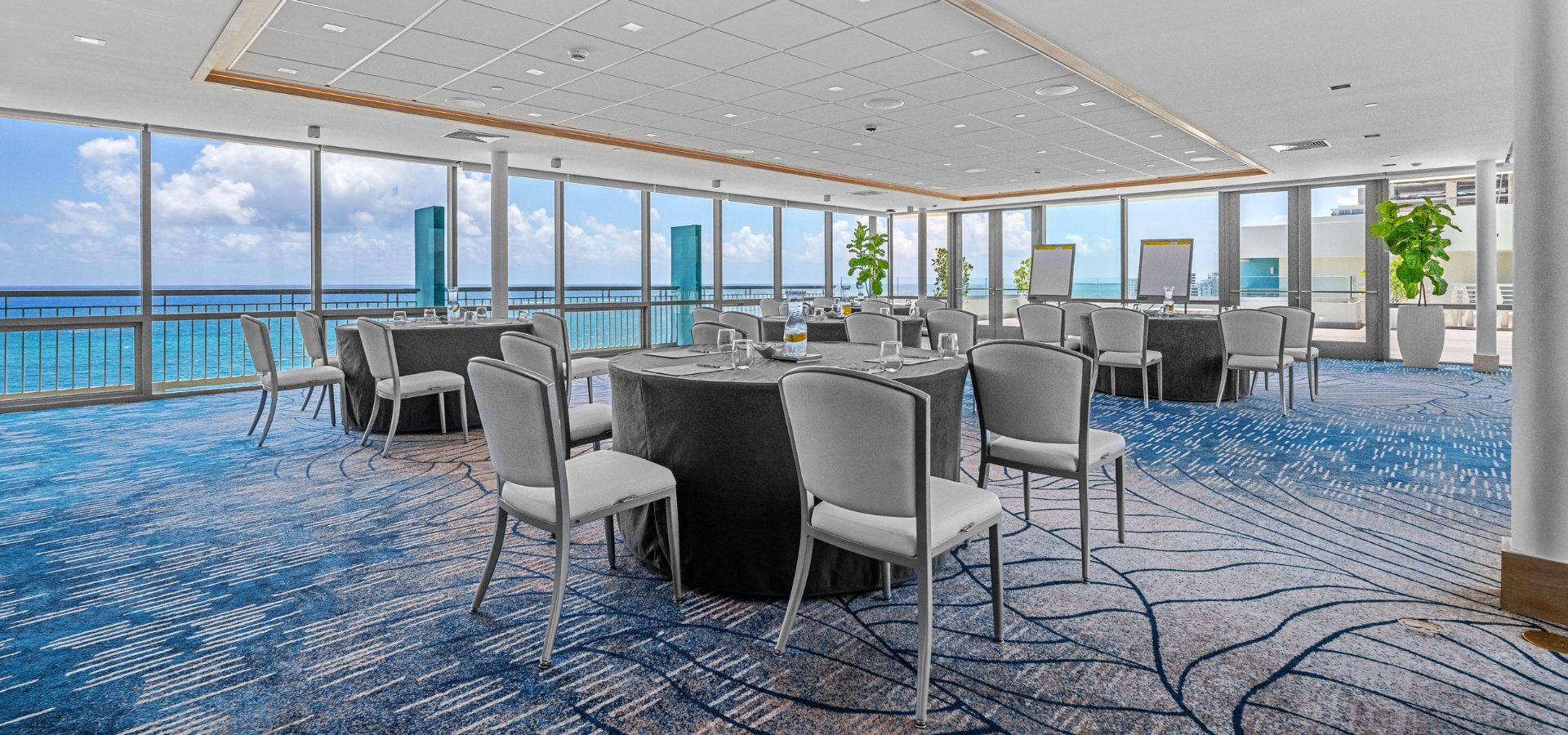 spacious banquet room with ocean view