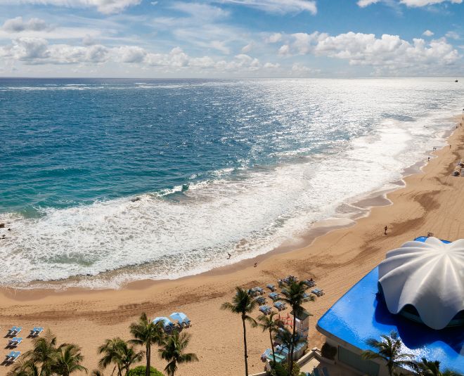 lady floating on pool overlooking the ocean.
