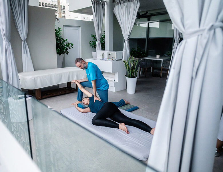 Nuad Boran Thai Massage with guest being gently stretched fully dressed