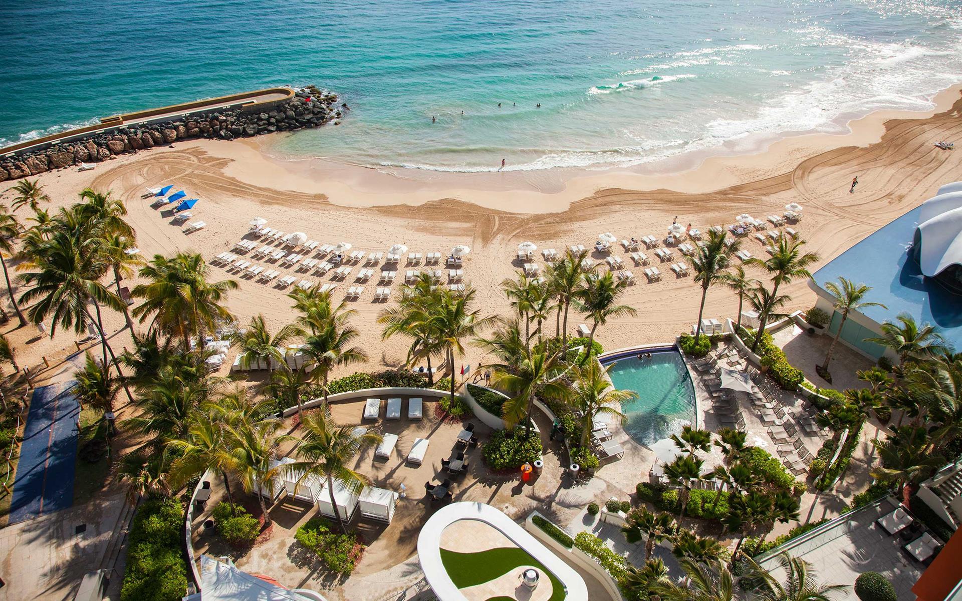 Aerial view of La Concha with white sand beach and beach chairs
