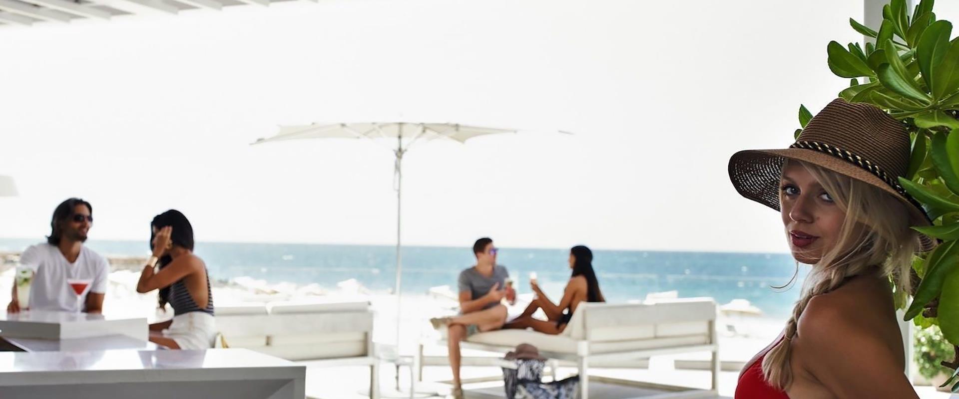 Lady sitting at the beach looking at the camera