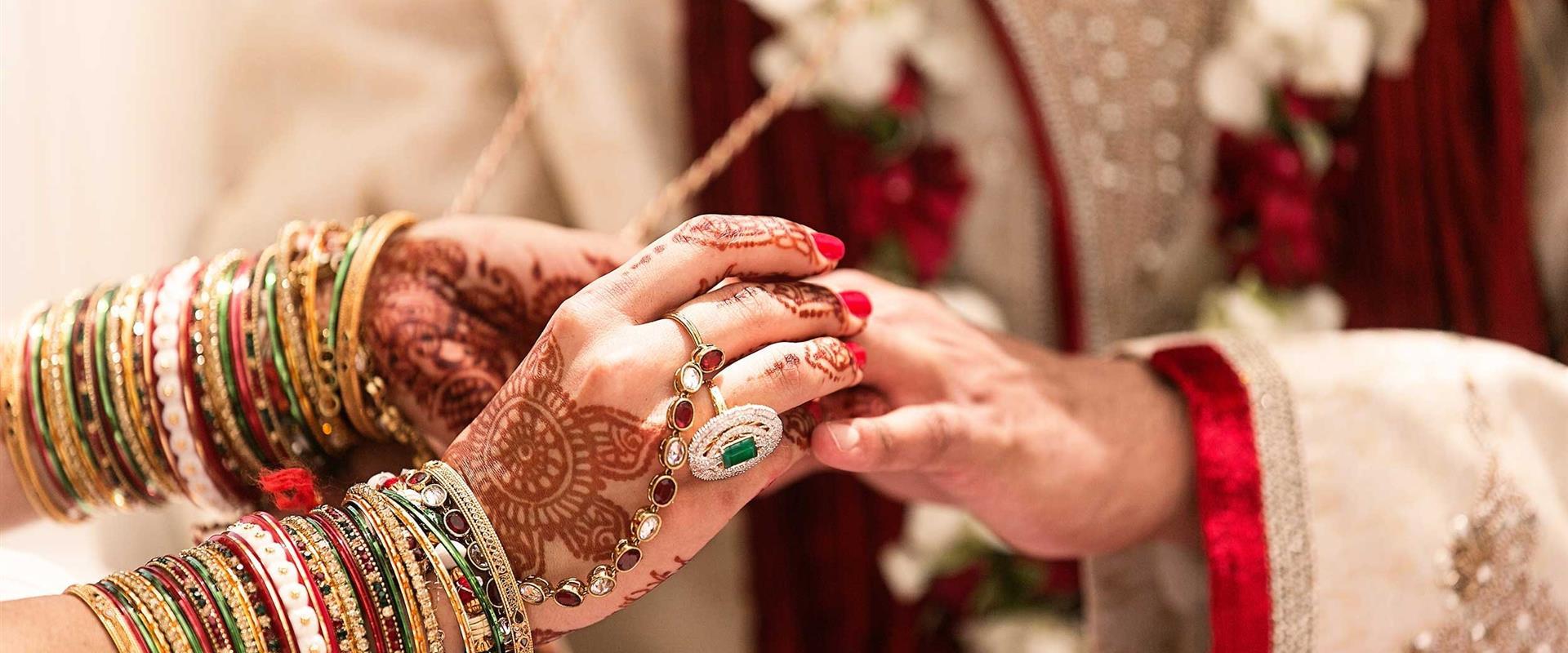 A woman with a lot of jewelry on her arms and hands