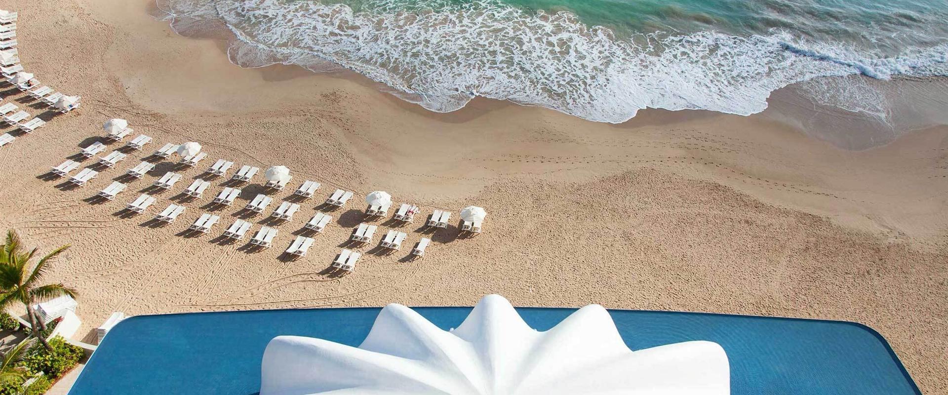 A beach with chairs and umbrellas