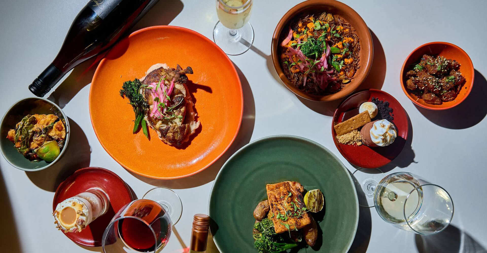 Dining spread with wine, dessert, entrees, and appetizers
