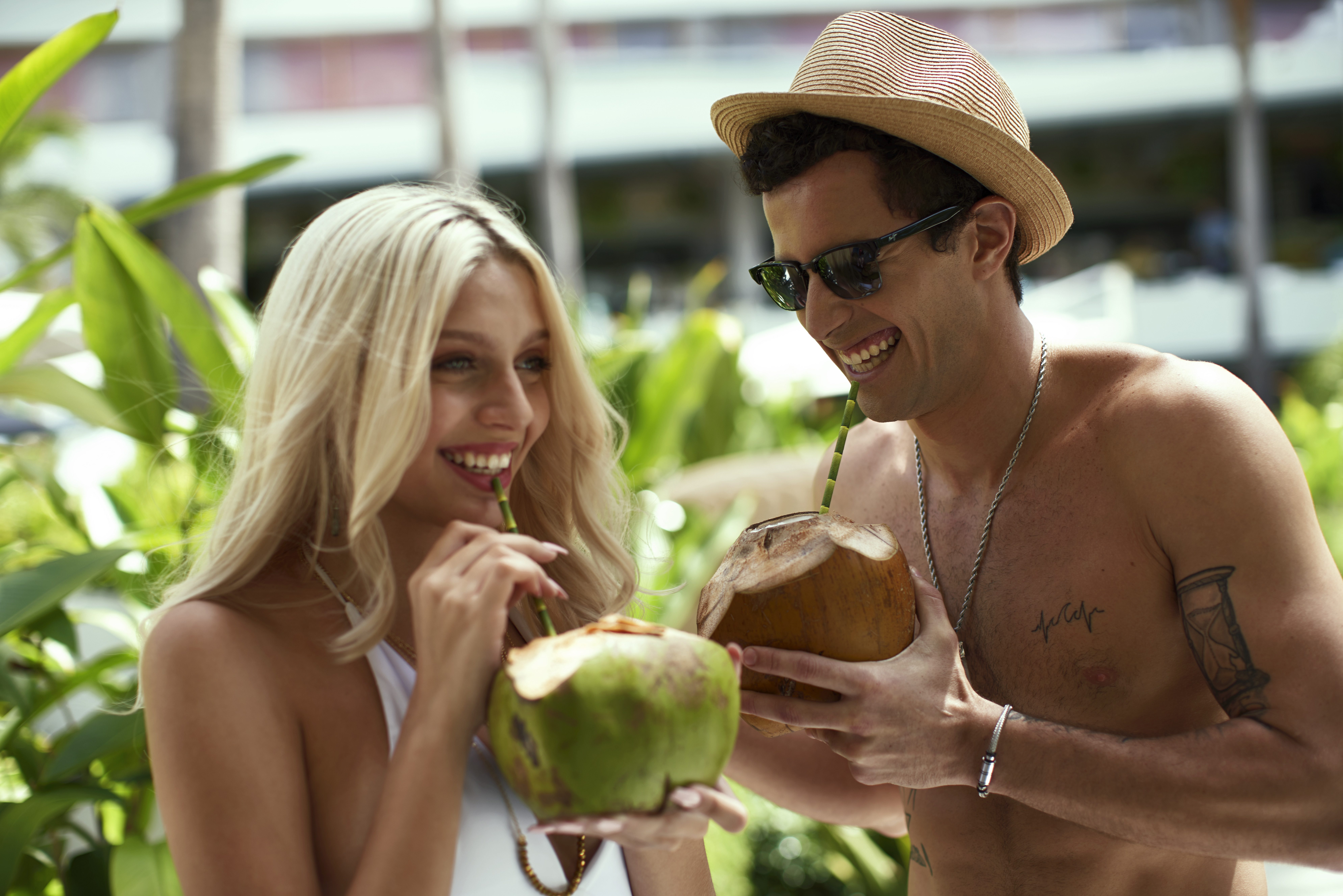 couple drinking coconut water at la concha resort san juan